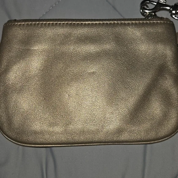 Coach metallic bronze wristlet featuring a detachable strap and a embossed logo - Picture 5 of 7